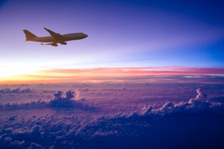 plane flying over colorful sky