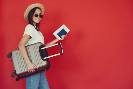 girl holding suitcase and passport